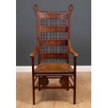 An early 20th century possibly German high backed chair with bobbin turned decoration and inset with
