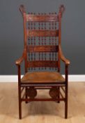 An early 20th century possibly German high backed chair with bobbin turned decoration and inset with