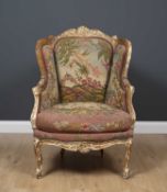 A 19th century continental beechwood framed wing back armchair with tapestry upholstery and cabriole