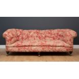 A Victorian button upholstered Chesterfield settee with turned feet and on easy glide casters, 213cm