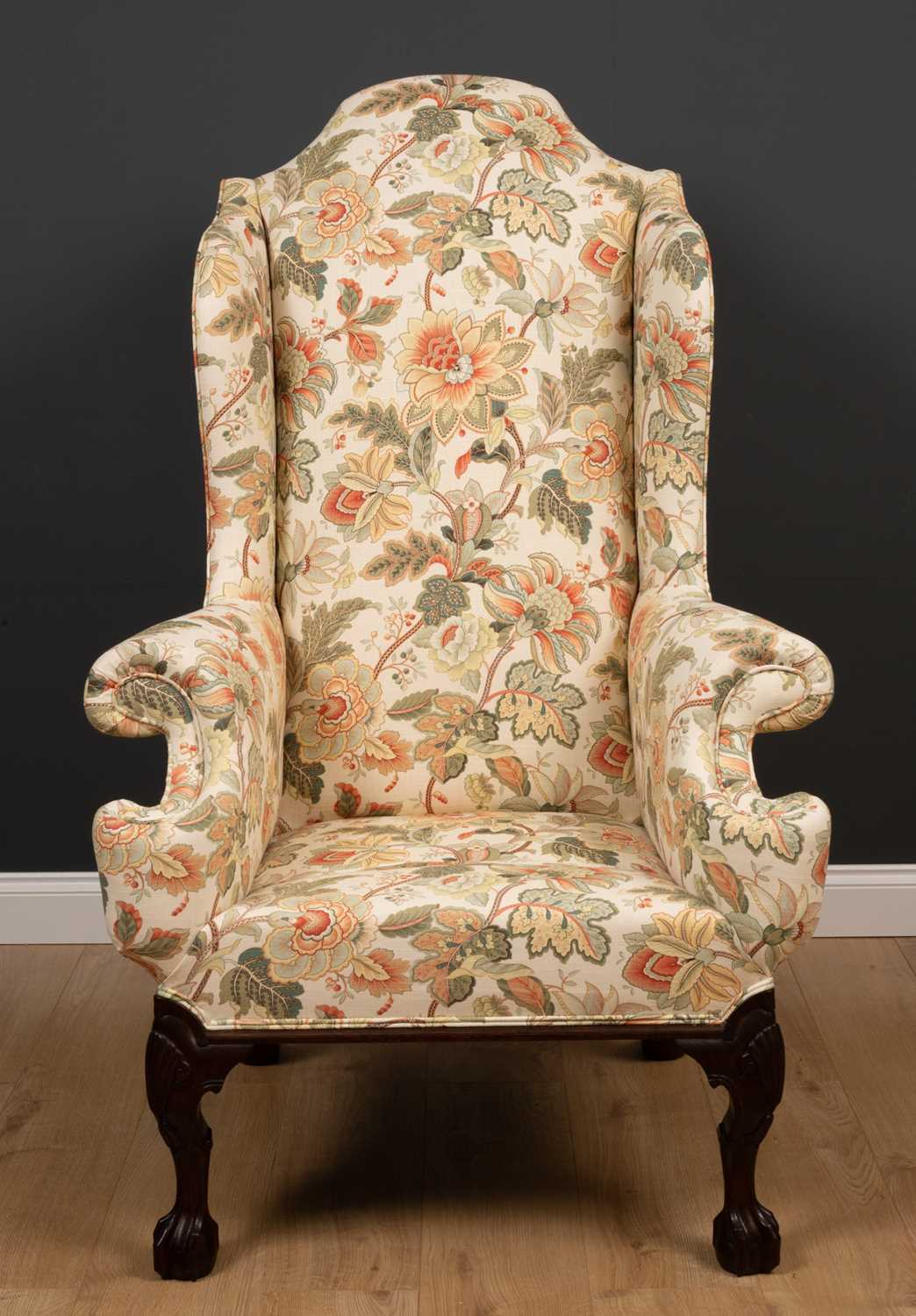 A George II style wingback armchair with floral upholstery and label for 'The Odd Chair Company'