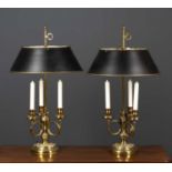 A pair of brass continental style table lamps with three scrolling branches supporting faux