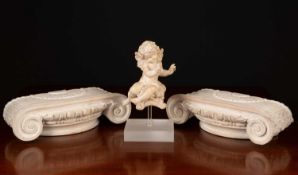 A limed carved wooden cherub mounted on a perspex stand together with two limed carved pine ionic