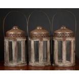 A set of three cylindrical tin and wood lanterns with glazed sides, 24cm diameter x 39cm high to the