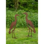 A pair of steel profile sculptures of heron each with a stake for standing in the lawn, 96cm high (