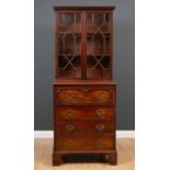 A George III mahogany secretaire bookcase of small size, the astragal glazed cabinet above enclosing