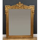 A 19th century gilt wall mirror with outset upper corners and central mask crest with floral and