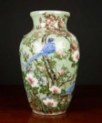 A modern Celedon glazed large baluster vase decorated with birds amongst prunus blossom, 25cm