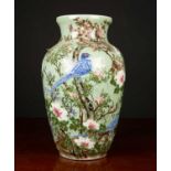 A modern Celedon glazed large baluster vase decorated with birds amongst prunus blossom, 25cm