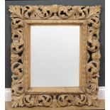 An antique and later carved pine rectangular hanging wall mirror with acanthus leaf decoration, 74cm