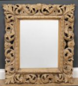 An antique and later carved pine rectangular hanging wall mirror with acanthus leaf decoration, 74cm