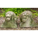 A pair of cast reconstituted stone Gothic style creatures perched on triangular section ridges, each