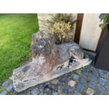 A pair of large composite stone recumbent lion statues each 127cm in length x 43cm deep x 71cm