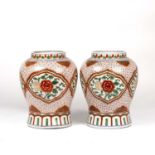 A pair of late 20th century Chinese style porcelain vases of baluster form with red and green