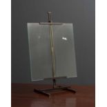 A contemporary bronze photographs frame in the form of a table top easel, the glass panel held