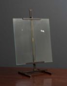 A contemporary bronze photographs frame in the form of a table top easel, the glass panel held