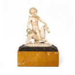 An antique possibly Italian carved ivory figure of a putti riding on the back of a goat, mounted