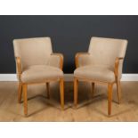 A pair of art deco beechwood framed armchairs with contemporary upholstery and tapering legs, 53cm