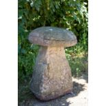 An old staddle stone with circular top and rectangular tapering base, approximately 53cm diameter