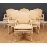 A set of six 18th century French style limed beechwood open armchairs with overstuffed upholstered