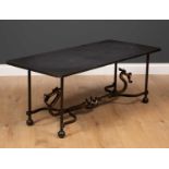 A wrought iron and black slate topped occasional table the rectangular top with canted corners,