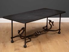 A wrought iron and black slate topped occasional table the rectangular top with canted corners,