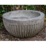 An Early English carved stone font, The fluted bowl in marble carved with belemnites on a