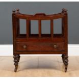 A Regency mahogany canterbury with four divided sections, brass stringing, drawer and on turned feet