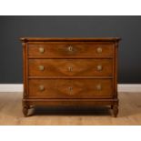 A late 19th or early 20th century French walnut three drawer commode, with outset pilaster columns