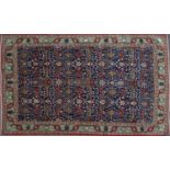 An Oriental blue ground floral rug with green ground triple banded border, 315cm x 211cmCondition