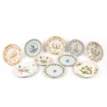 A group of eight various Faience plates decorated with figures, birds, vases of flowers etc, the