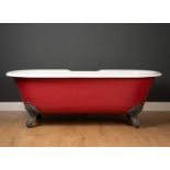 A Victorian style cast iron enamelled roll top bath with cast claw and ball feet, 162cm wide x