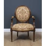 A 19th / early 20th century walnut framed open armchair with upholstered back and seat, 62cm wide