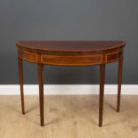 A George III mahogany demi lune fold over tea table with satinwood crossbanded decoration and square