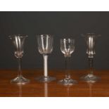 Two antique wine glasses with bell shaped bowls and folded feet, each 16cm high together with an old