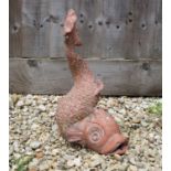 A cast terracotta fountain head in the form of a dolphin with scrolling tail, 41cm highCondition