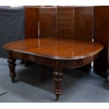 A large Victorian mahogany extending dining table with six turned supports, having large brass and