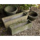 Two cast reconstituted stone troughs or planters together with three further planters, the largest