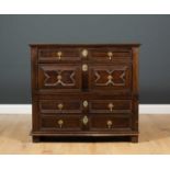 A 17th century and later chest of four drawers with mitred decoration and panelled sides, the