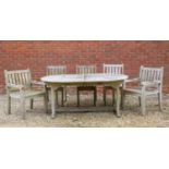 A teak garden dining table with rounded ends together with a group of five teak chairs to match (two