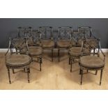 A set of eight Regency style dining chairs with painted decoration on an ebonised ground, all