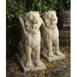 A pair of cast reconstituted stone sculptures of winged and horned lions, each approximately 70cm