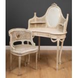 An early 20th century white painted kidney shaped dressing table with raised back with inset oval