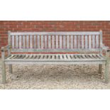 A teak garden bench 190cm wide x 90cm highCondition report: In weathered and used condition,