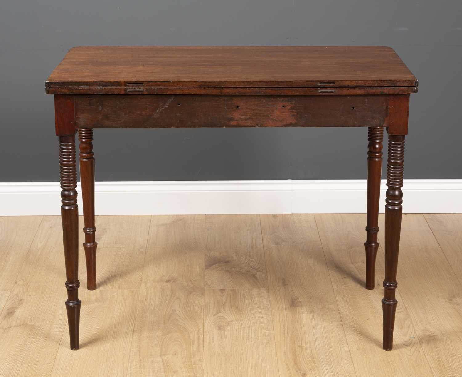 A George III fold over tea table with ring turned tapering legs and decorative inlay to the frieze - Image 3 of 5