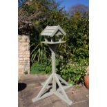A green painted wooden bird table on a splaying base, 66cm highCondition report: Weathered and