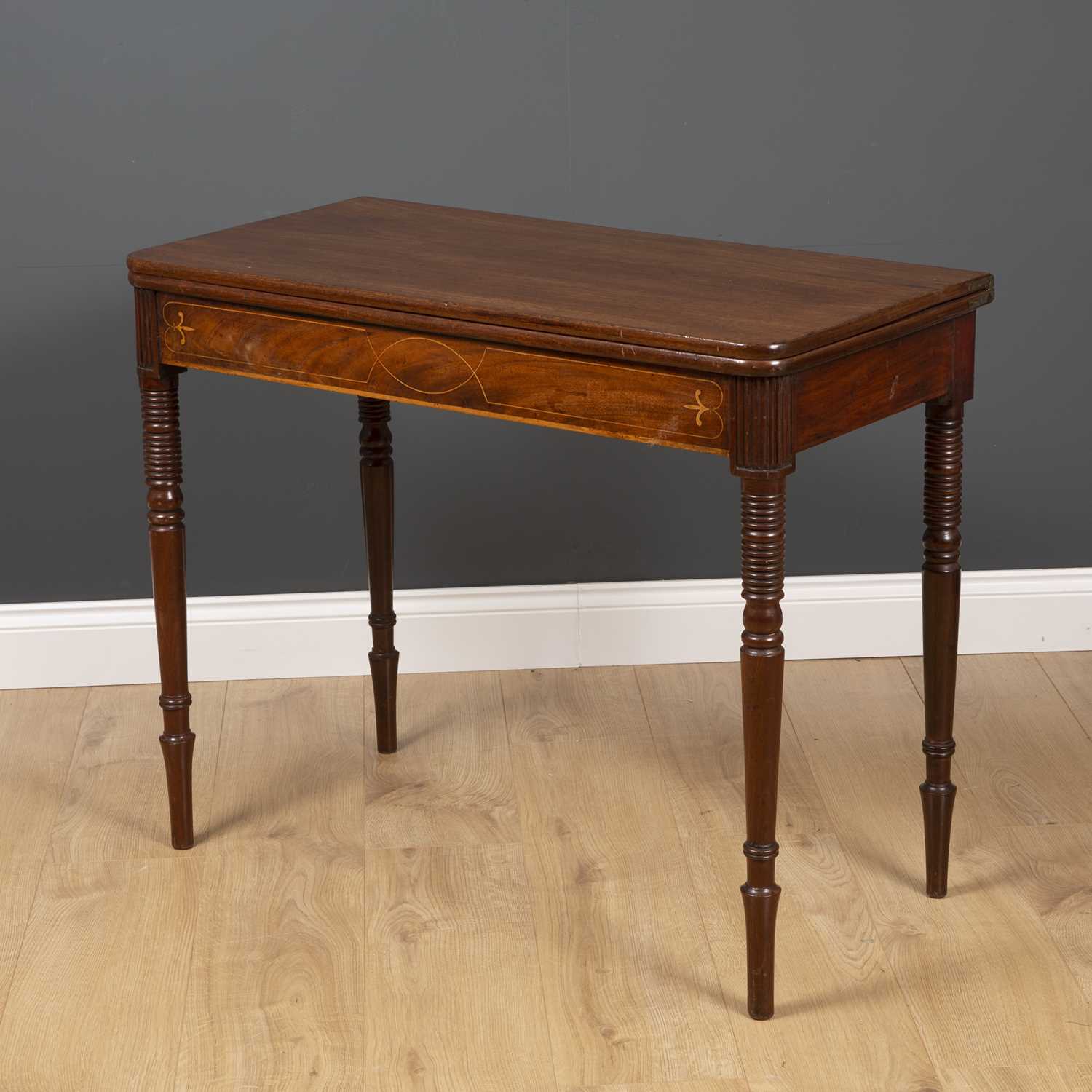 A George III fold over tea table with ring turned tapering legs and decorative inlay to the frieze - Image 2 of 5