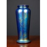 An art deco Ruskin iridescent lustre vase with tapering cylindrical form and spreading base,