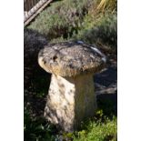 A matched set of three staddle stones with square tapering bases and circular tops, each