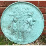 A green painted cast concrete roundel depicting a classical maiden playing pipes for a fawn, 50cm